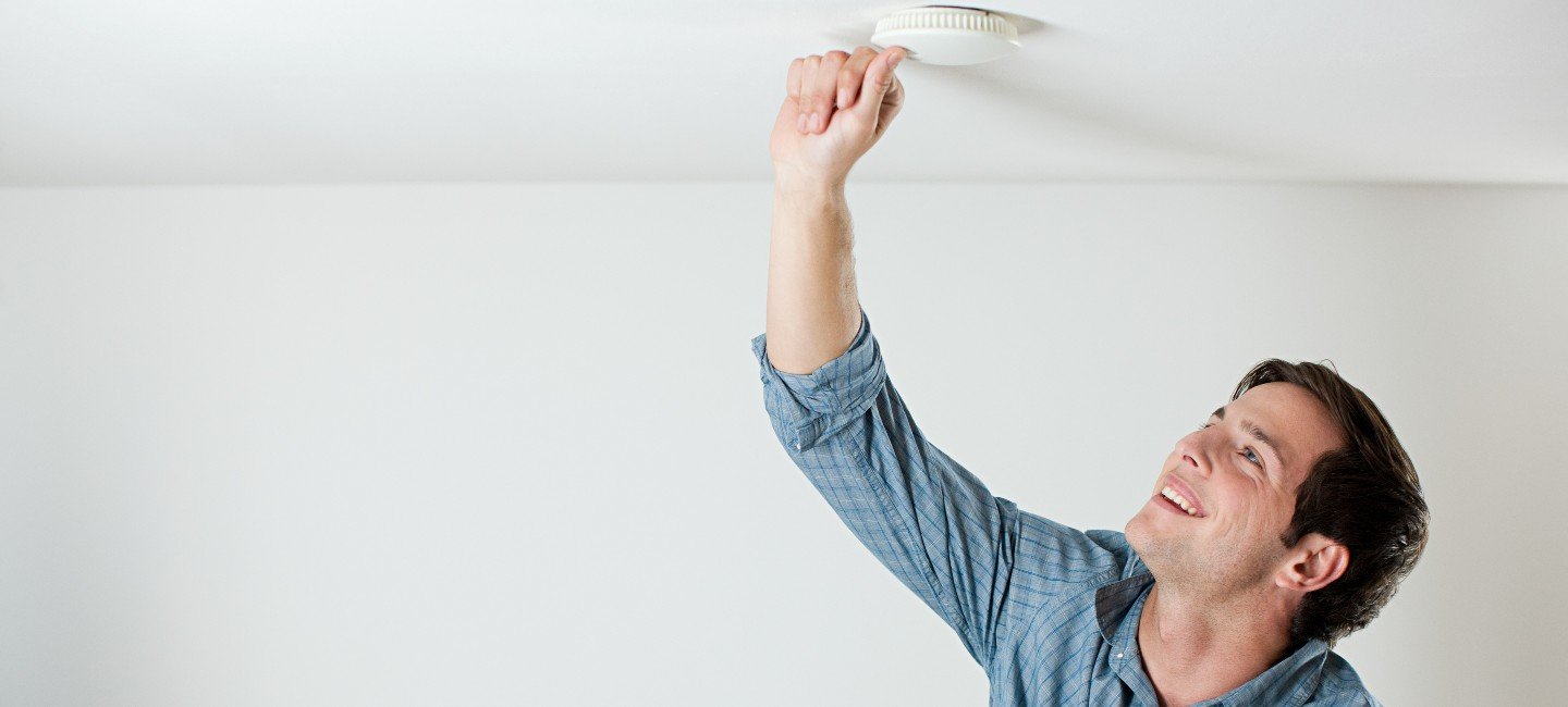 men checking smoke detector